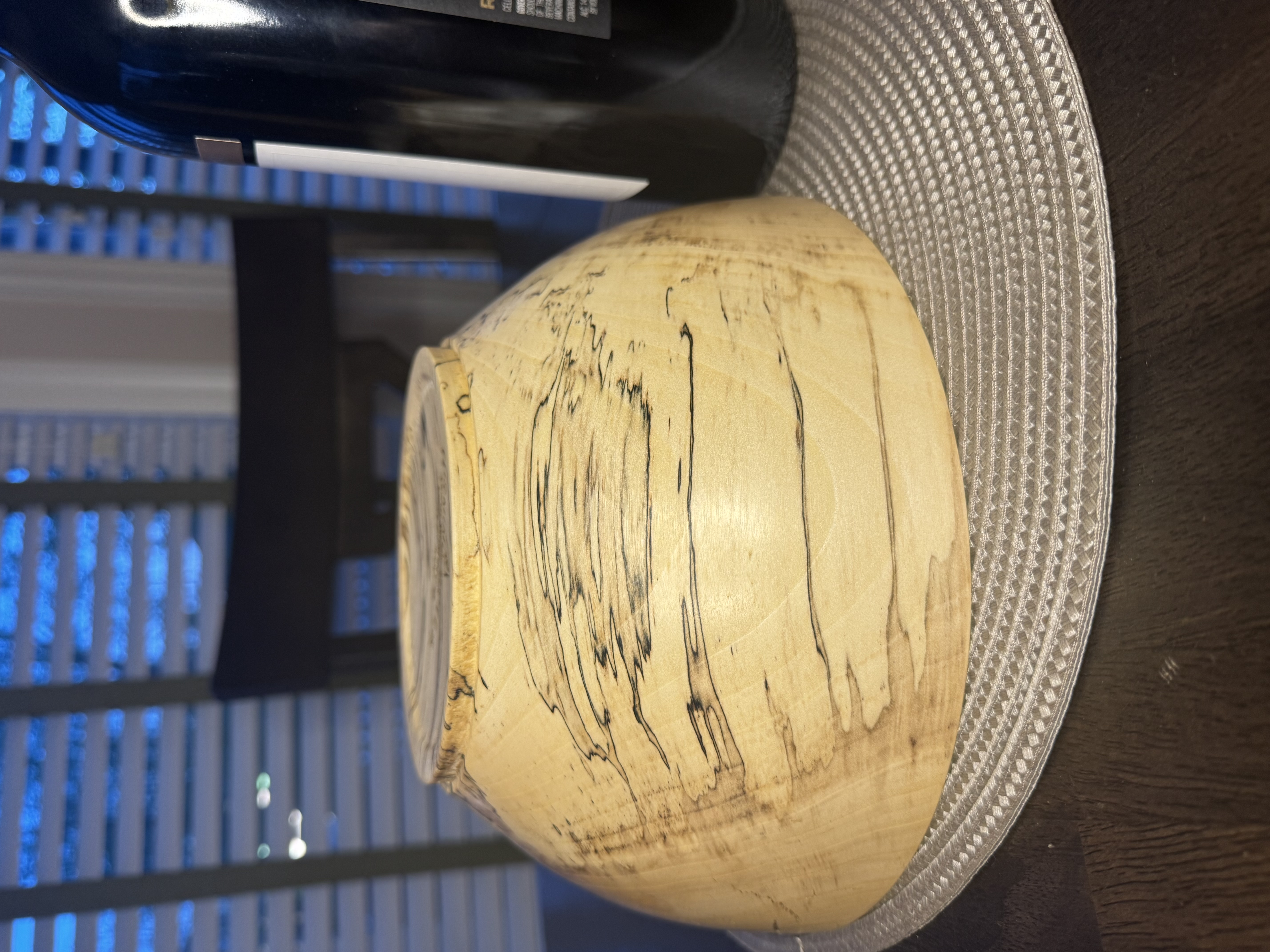 Close-up detail of spalted maple bowl showing dramatic black zone lines and fungal figure in pale wood