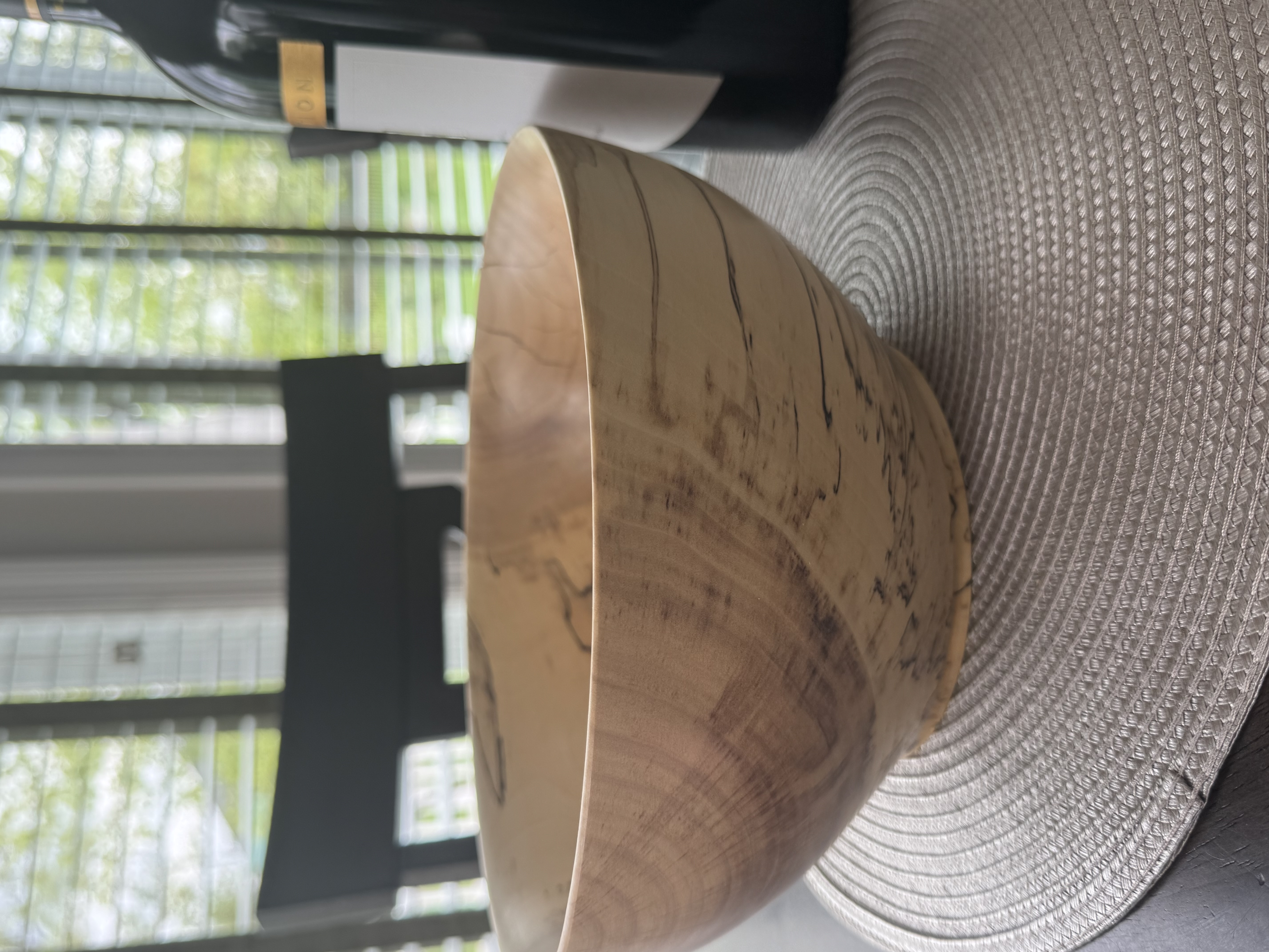 Close-up detail of spalted maple bowl showing dramatic black zone lines and fungal figure in pale wood