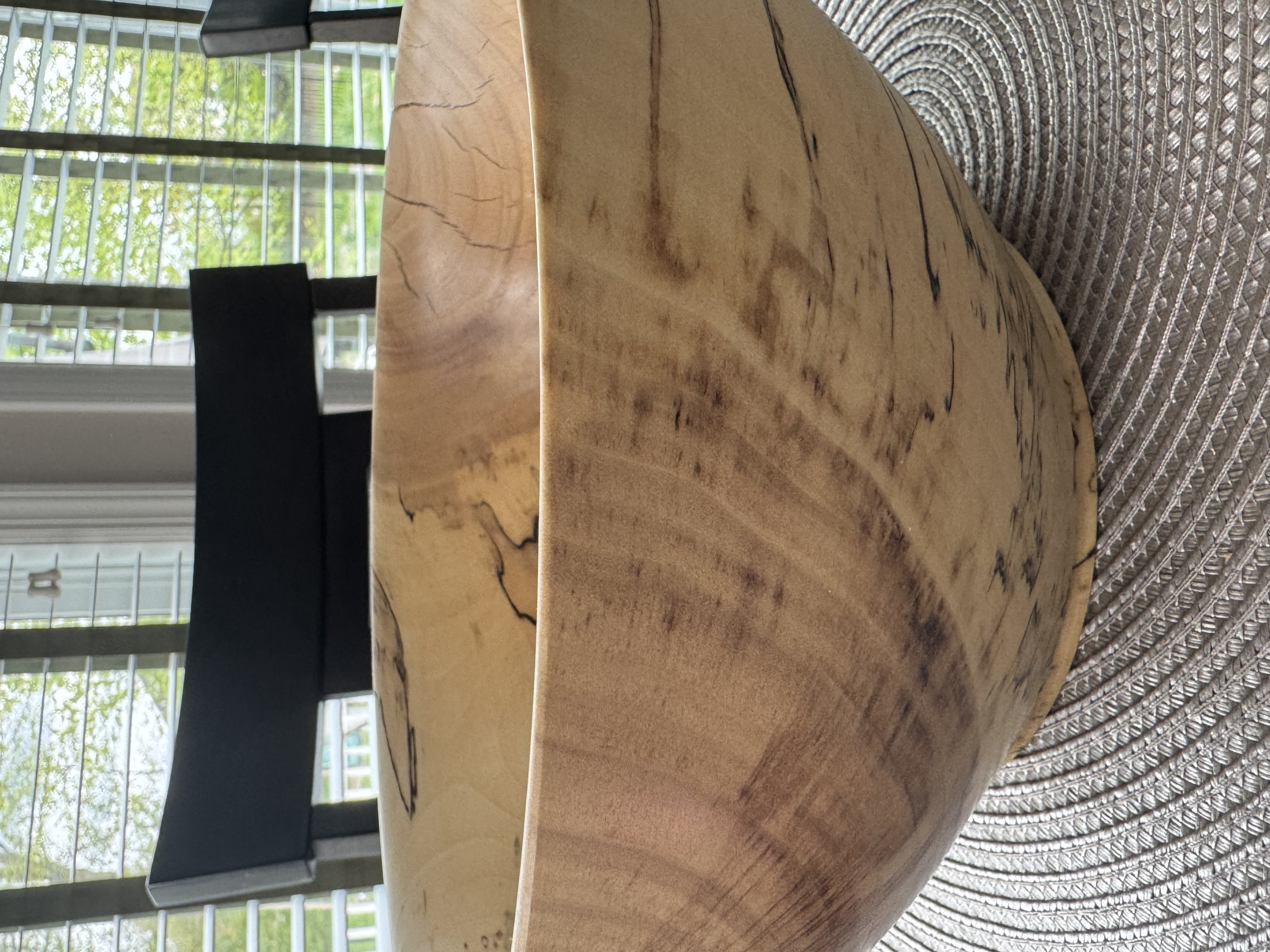 Close-up detail of spalted maple bowl showing dramatic black zone lines and fungal figure in pale wood