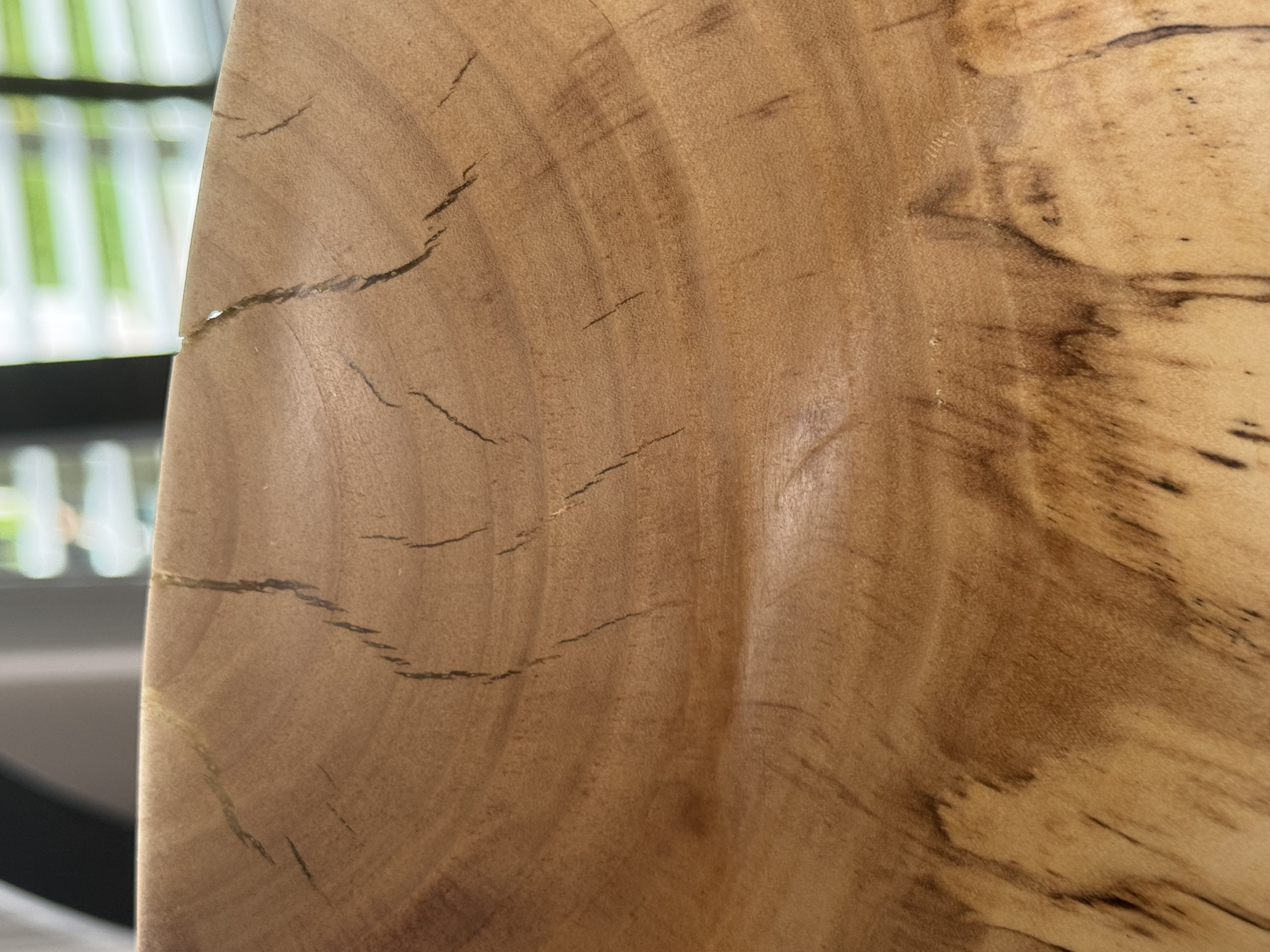 Close-up detail of spalted maple bowl showing dramatic black zone lines and fungal figure in pale wood