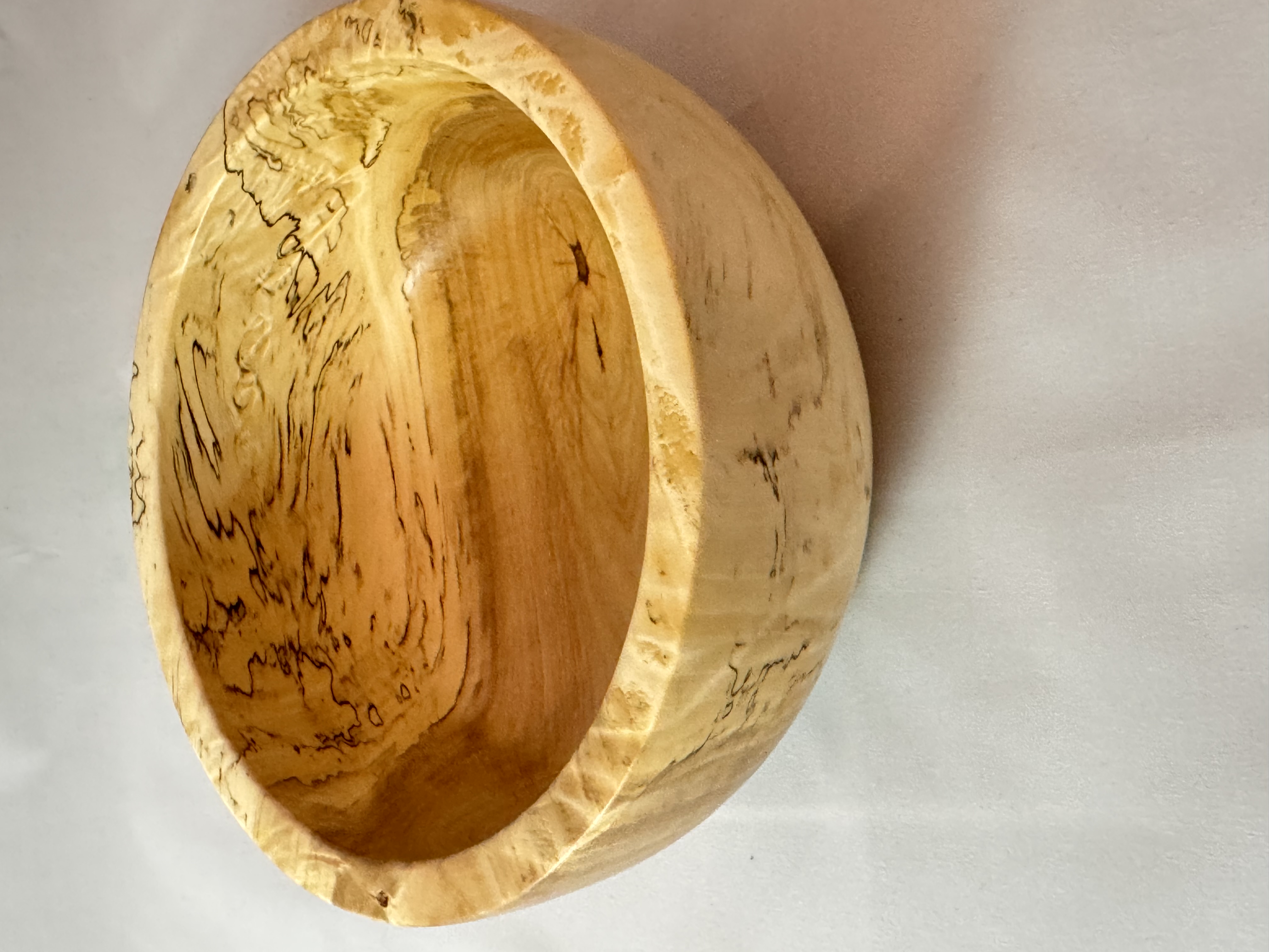 Small spalted maple bowl with dark zone lines and a compact rounded form