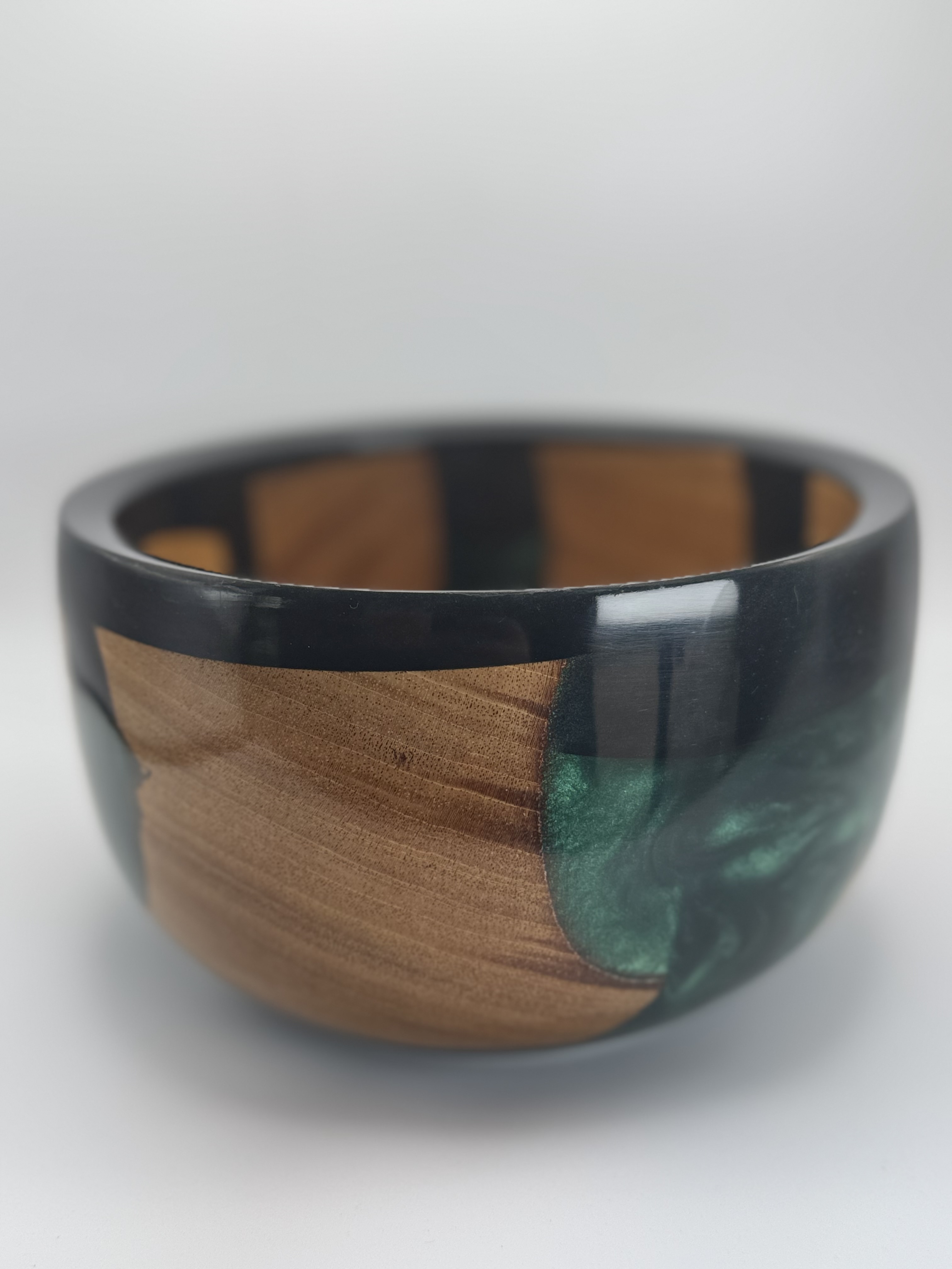 Close view of cherry wood grain beside deep green resin